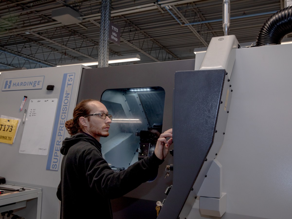 A man operates industrial equipment.