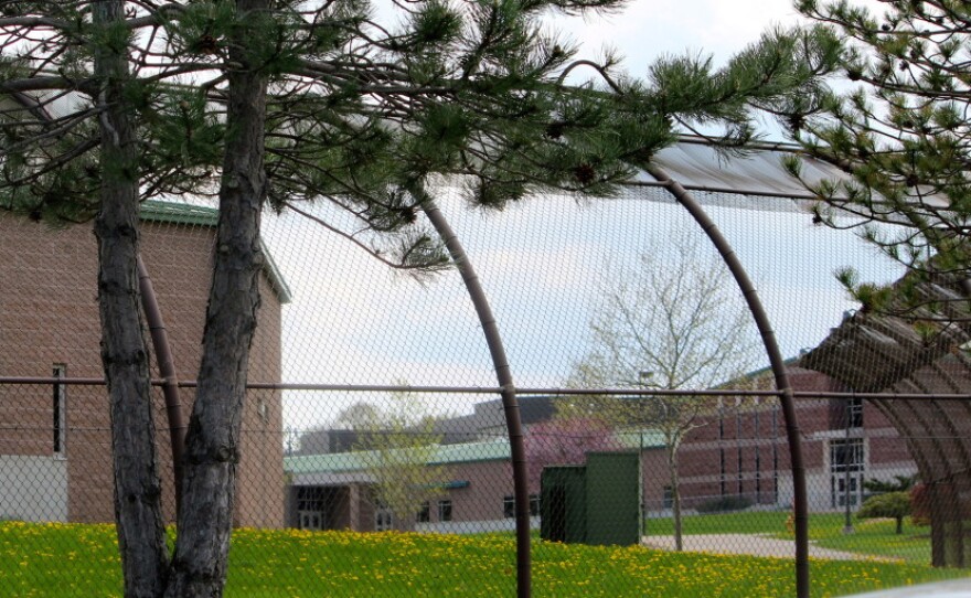 The former Connecticut Juvenile Training School in Middletown can be seen through tall arched gates.