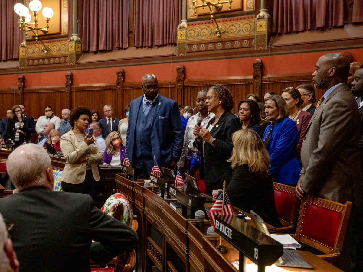 Legislators gather behind Rep. Toni Walker, D-New Haven, in a show of support as she explains the significance of Juneteenth on the floor of the state House of Representatives on May 4, 2022.