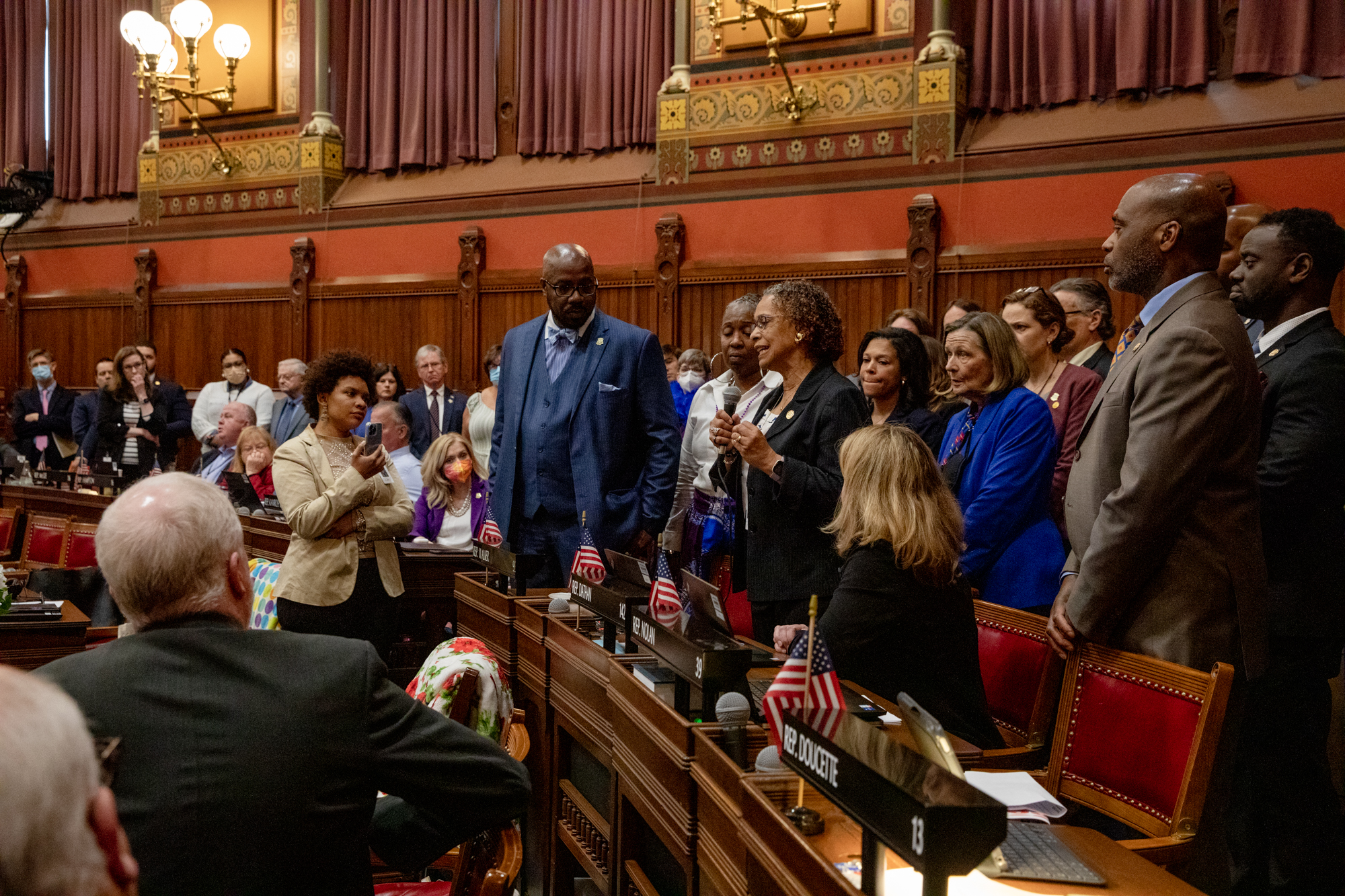 Legislators gather behind Rep. Toni Walker, D-New Haven, in a show of support as she explains the significance of Juneteenth on the floor of the state House of Representatives on May 4, 2022.