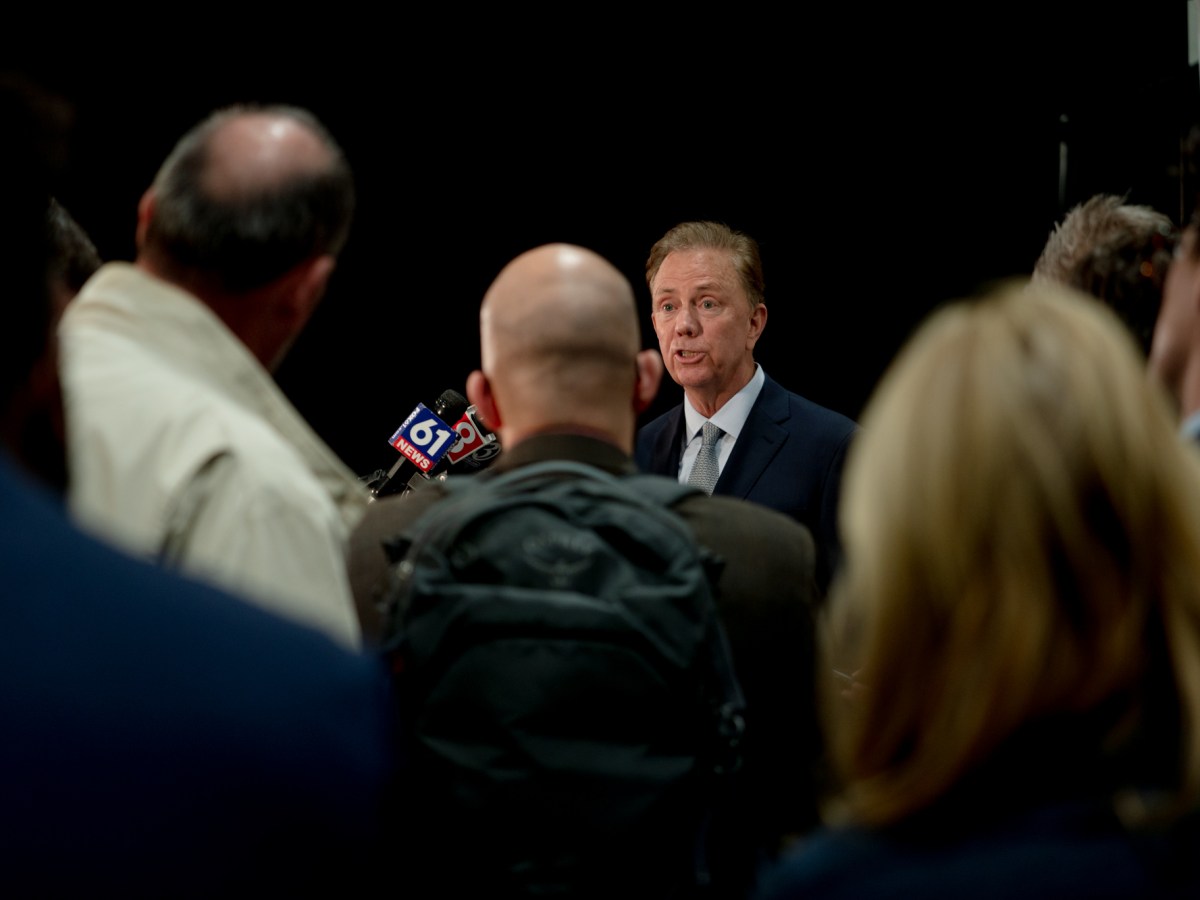 Gov. Ned Lamont and members of the press.