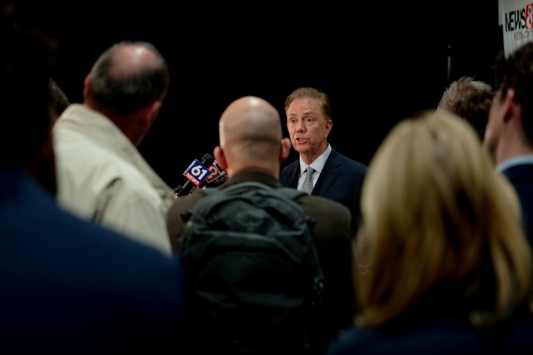Gov. Ned Lamont and members of the press.