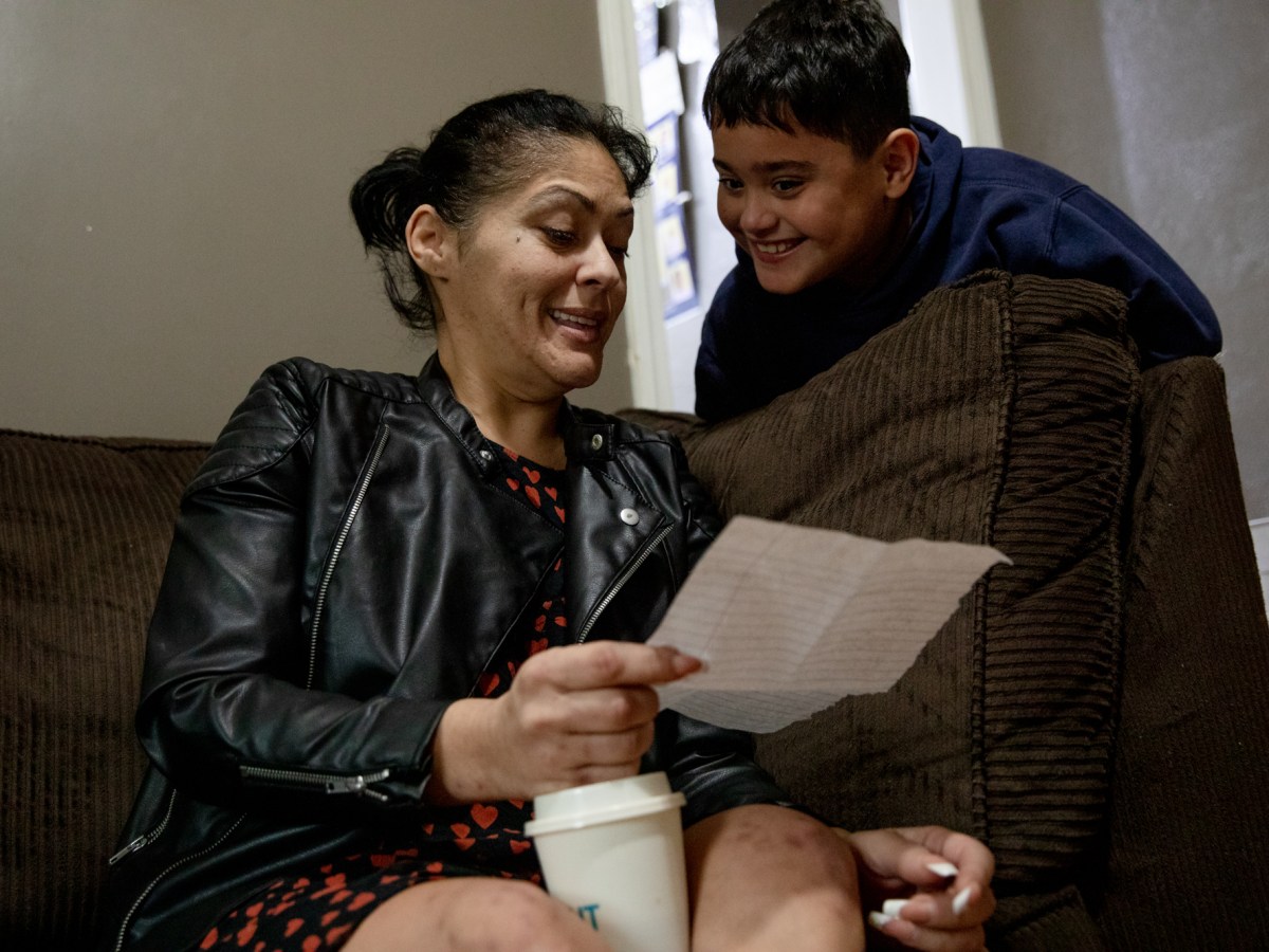 A boy and his mother look over his Christmas list.