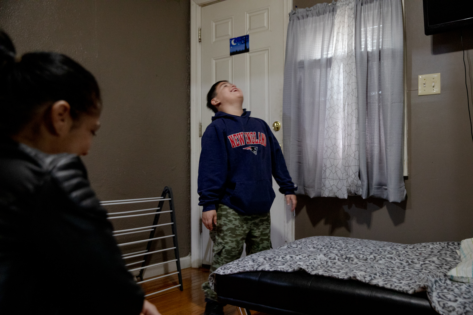 A boy laughs with his mother.