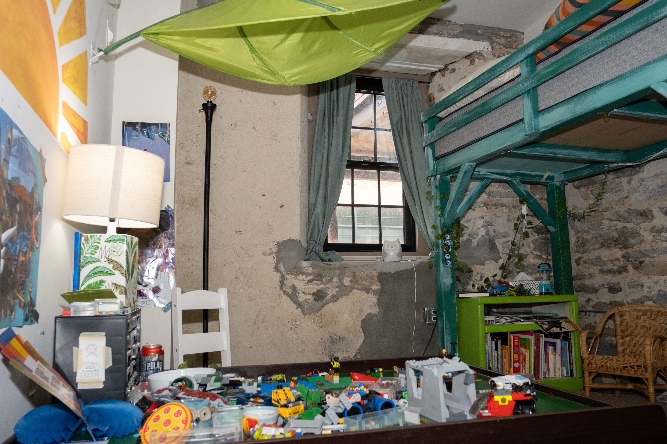 A wall in Kate Slininger's apartment at Cargill Falls Mill in Putnam, CT is unsealed. This causes debris to constantly crumble near her son's bed.