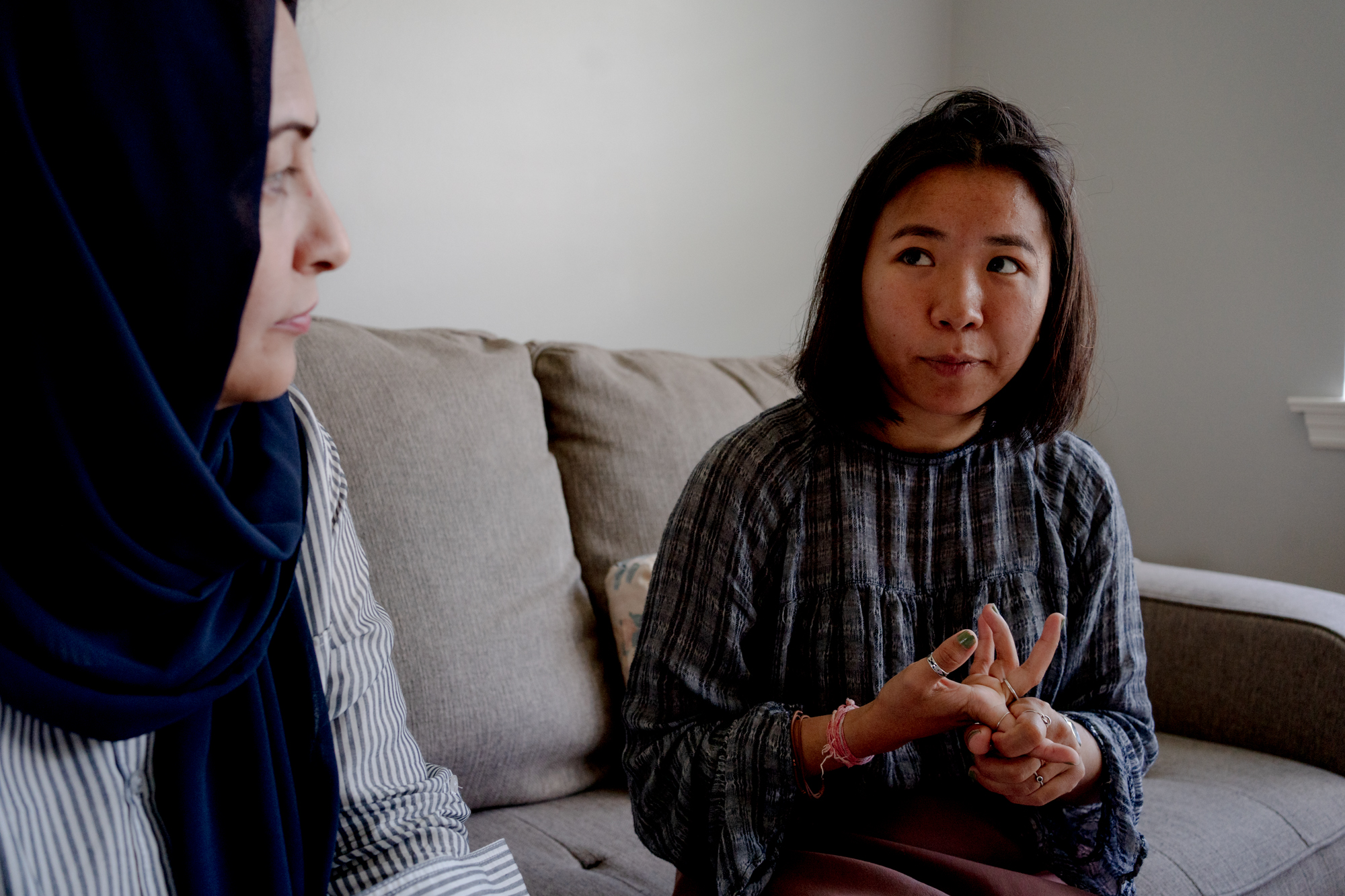Aiti Rai and Palwasha Azimi sit side by side on a couch.