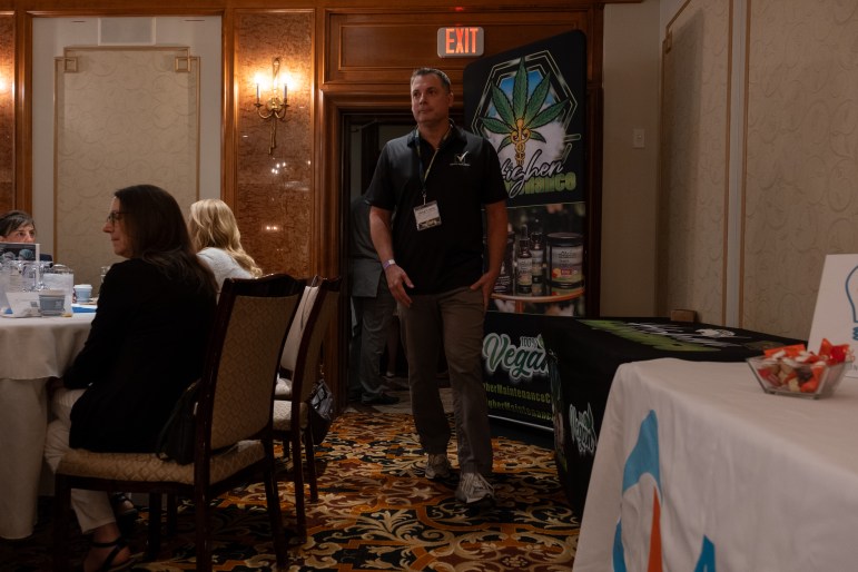 A man walking into a hotel conference room.