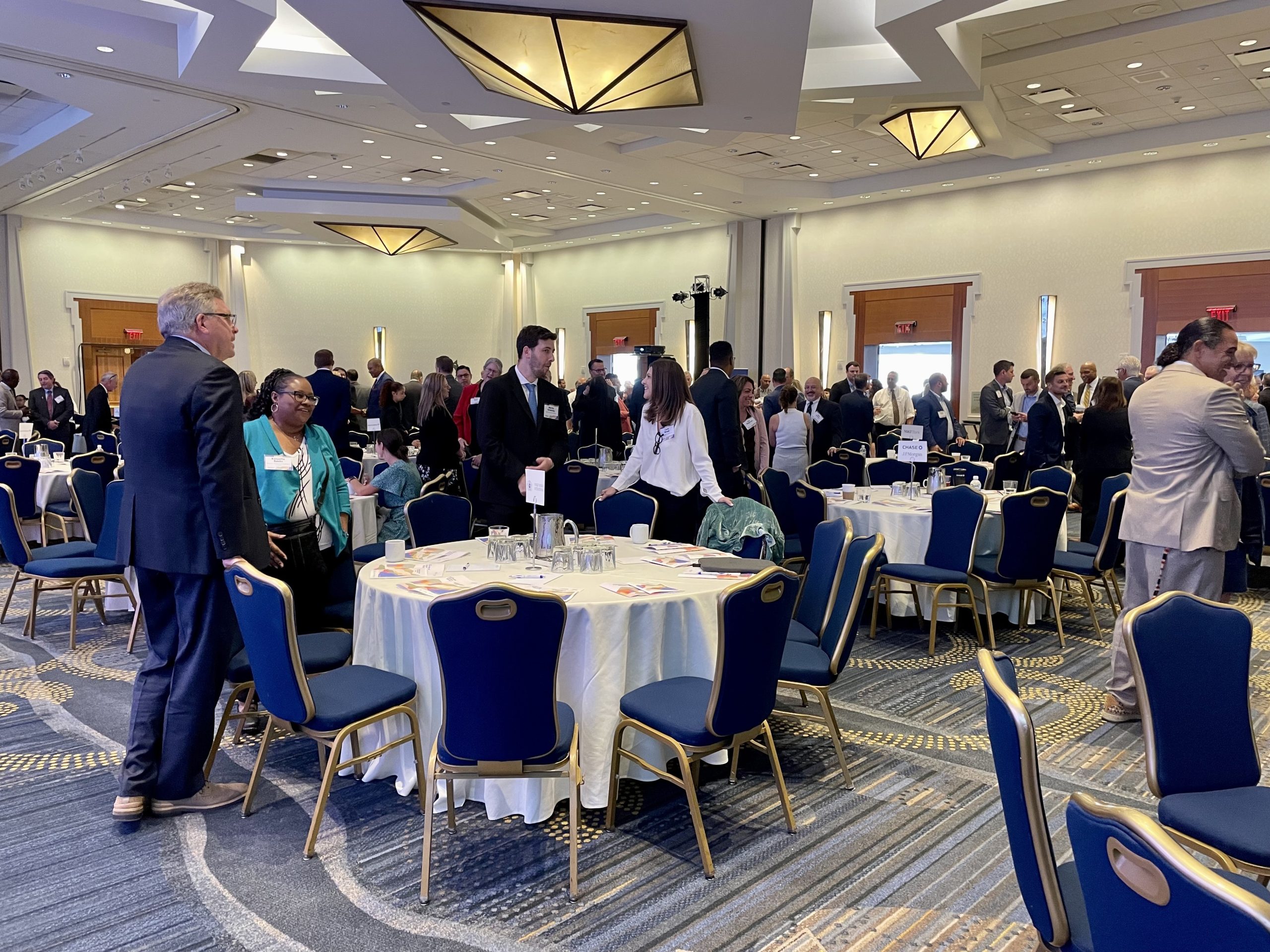 Attendees at a business event chat with each other during a break.