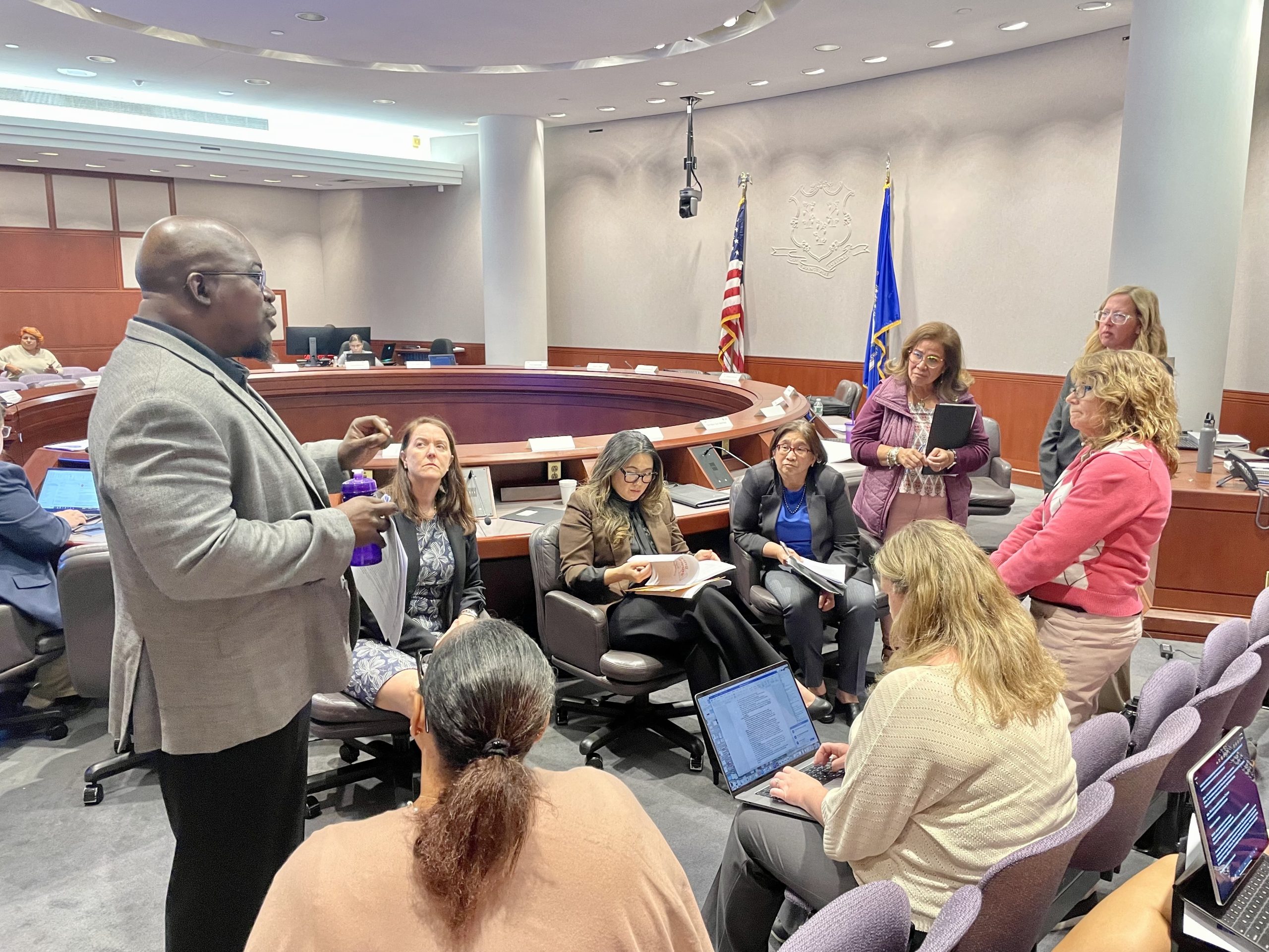 People talk in a meeting room.