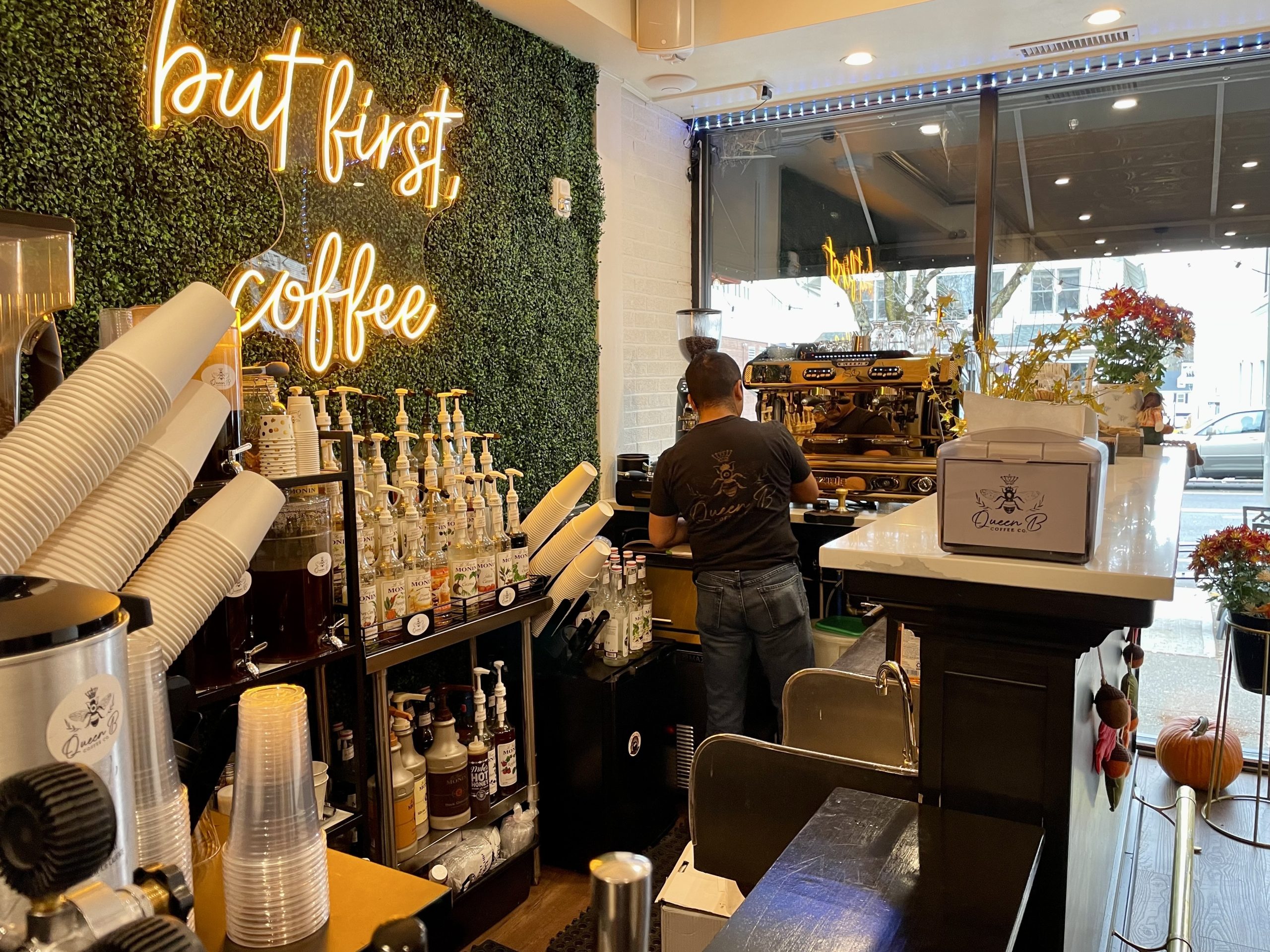 A coffee shop worker cleans the barista machine.