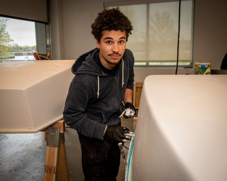 A young man in a workshop.