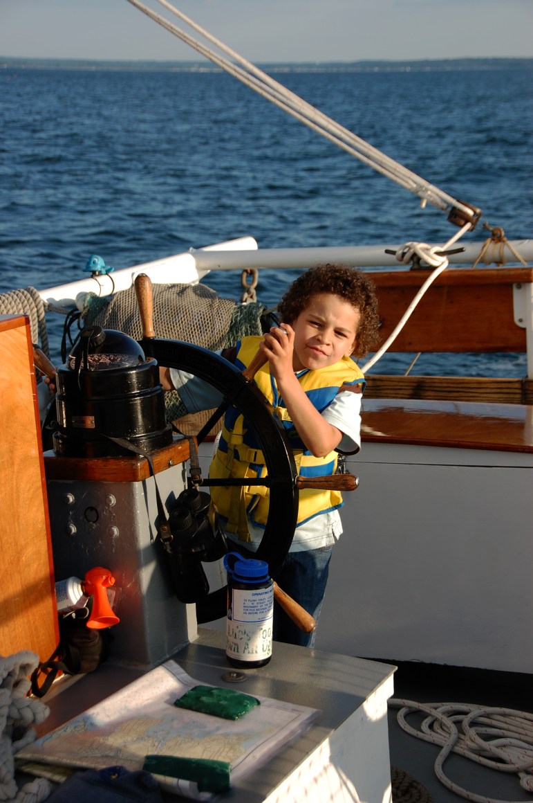 A child steering a boat.