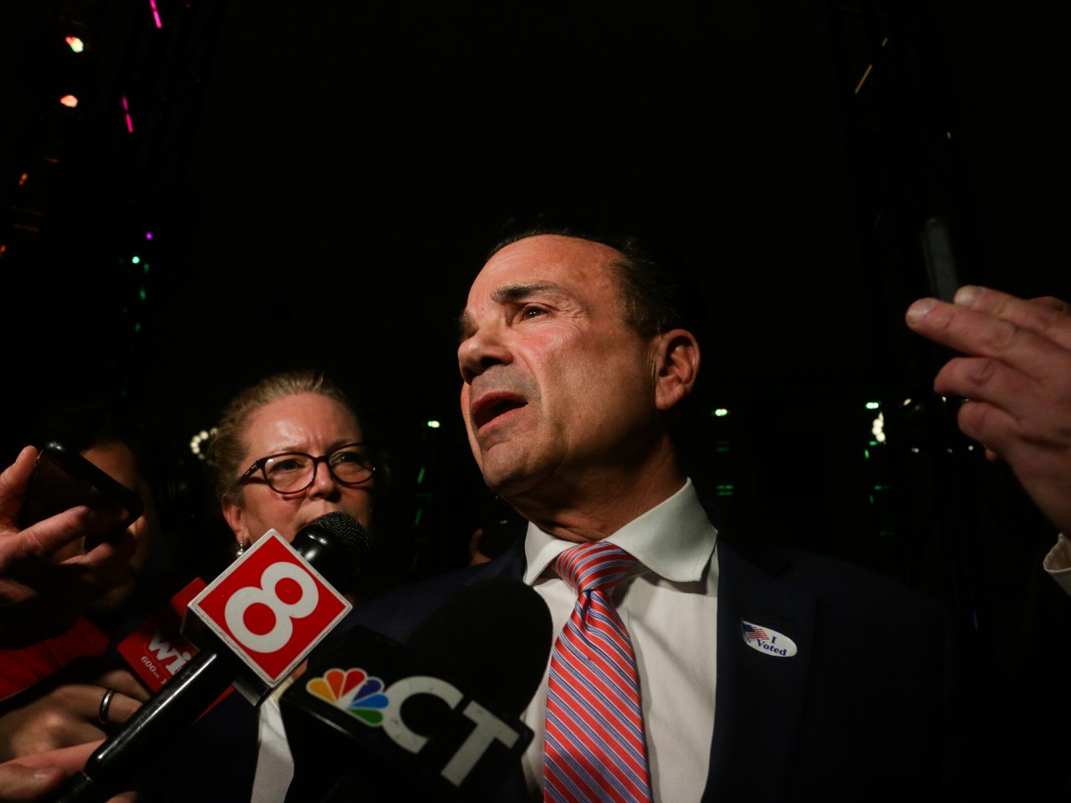 Joe Ganim is speaking to members of the press, who have TV microphone pointed in his direction.