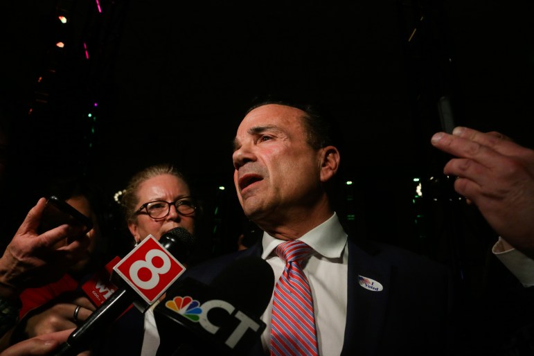 Joe Ganim is speaking to members of the press, who have TV microphone pointed in his direction.