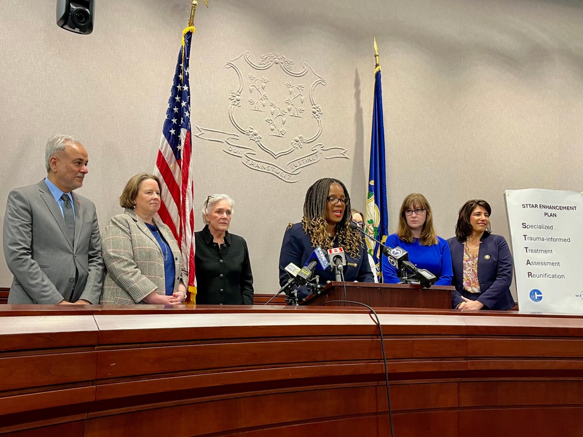 Jodi Hill-Lilly, commissioner-designee for Connecticut's Department of Children and Families, announces policy changes about STAR group homes on Thursday, March 14. State lawmakers stand alongside her as she makes her announcement in Hartford.