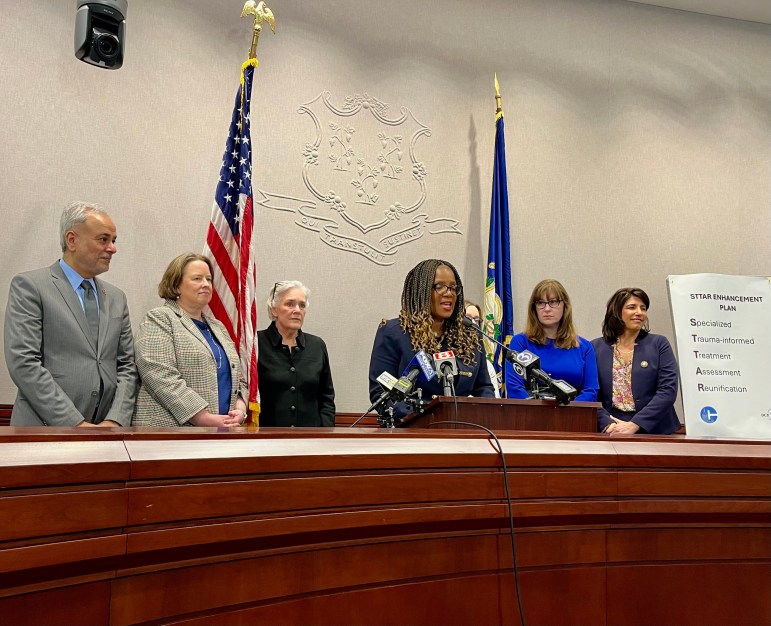 Jodi Hill-Lilly, commissioner-designee for Connecticut's Department of Children and Families, announces policy changes about STAR group homes on Thursday, March 14. State lawmakers stand alongside her as she makes her announcement in Hartford.