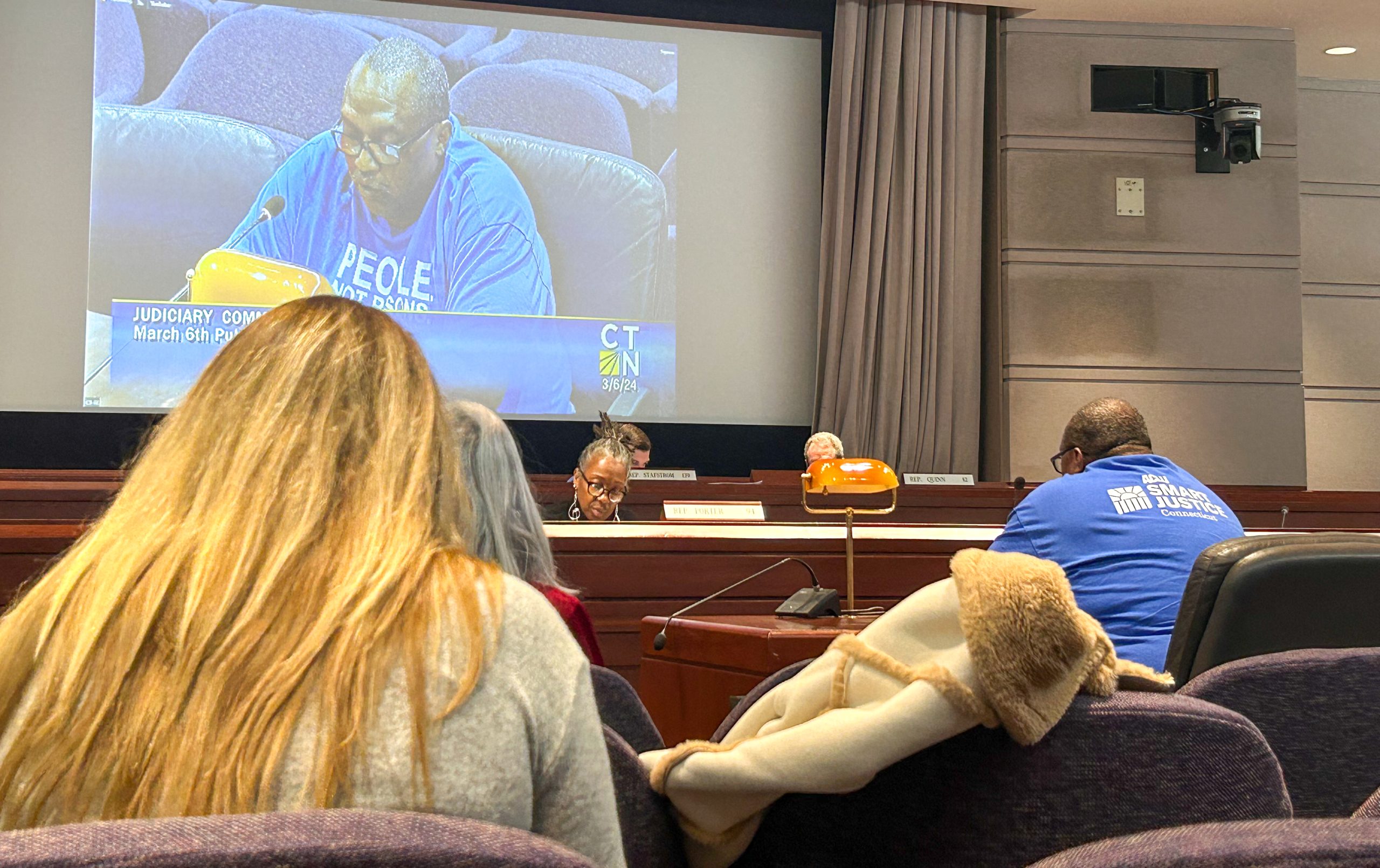 Anderson Curtis is seen on a projector screen in Hartford's Legislative Office Building.