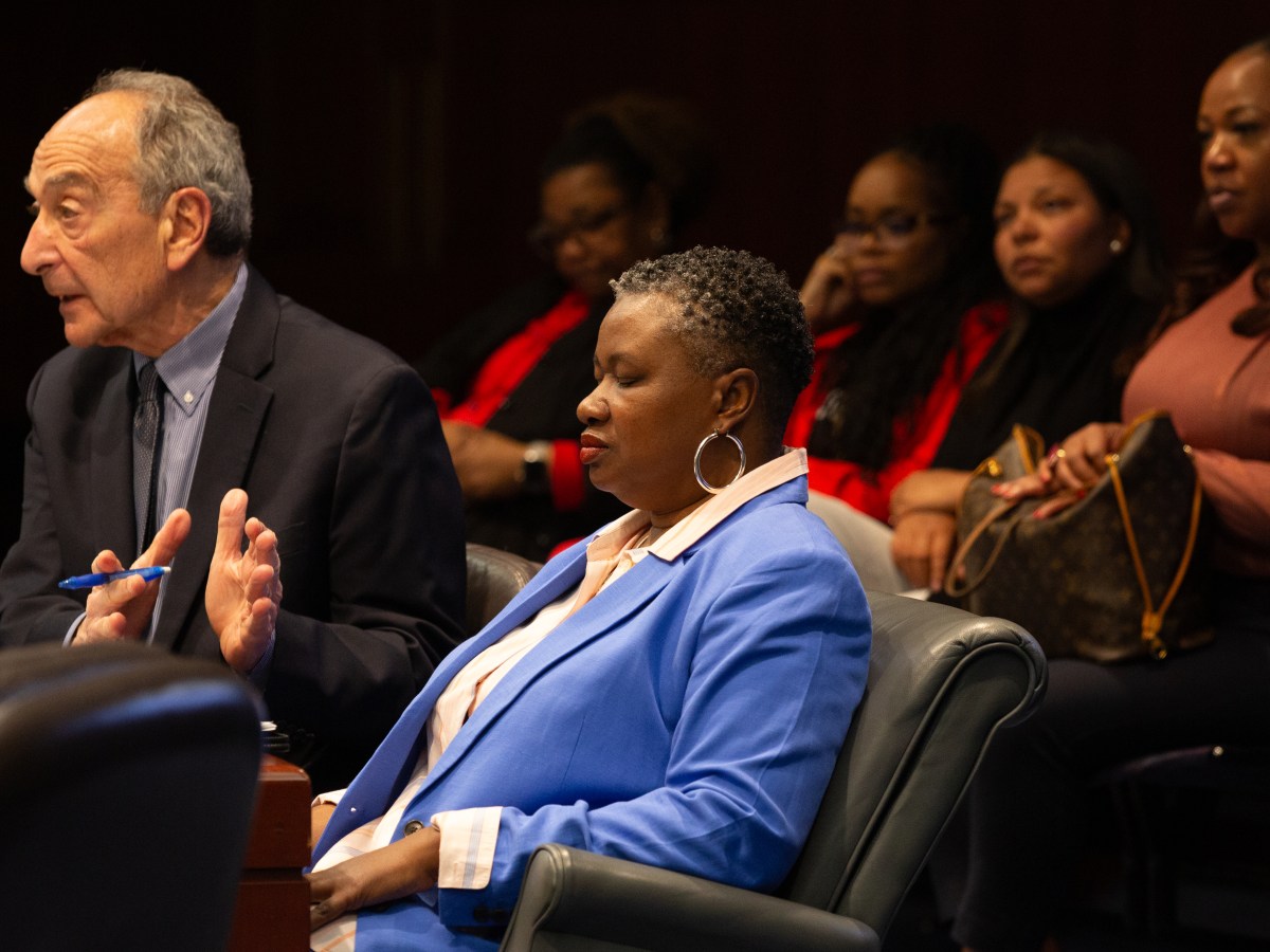 TaShun Bowden-Lewis closes her eyes for a brief moment as she listens to her attorney, Thomas W. Bucci, speak to the Public Defender Services Commission.