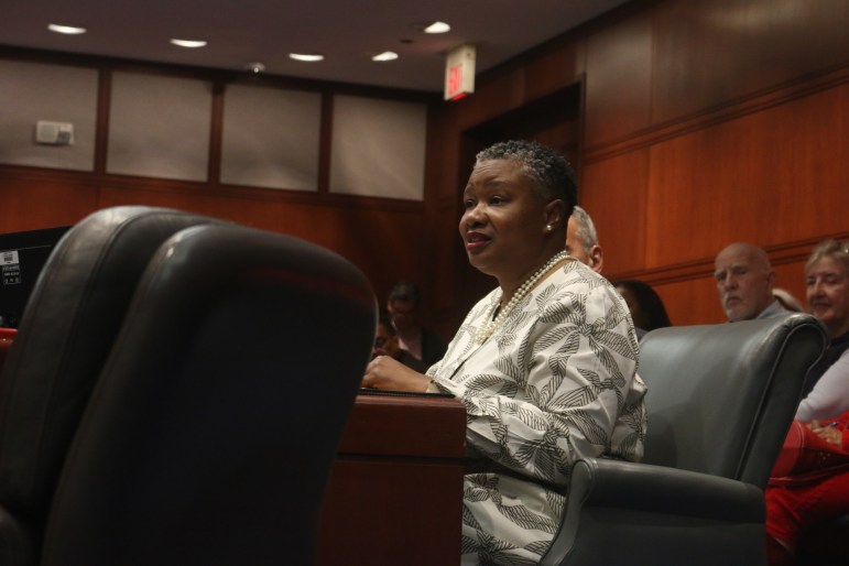 TaShun Bowden-Lewis is sitting in a chair and speaking as she looks at other people not in the frame.