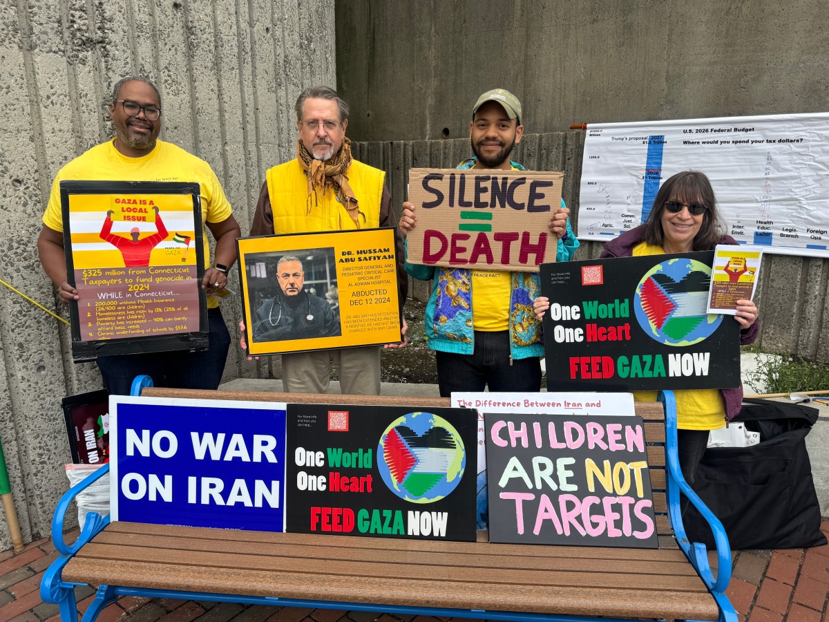 At Bridgeport’s train station, a small group asks residents to pause and think